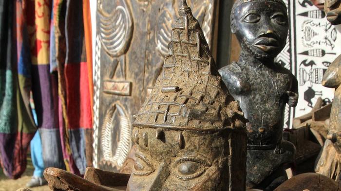 Kunsthandwerk, Masken und Plastiken auf einem afrikanischen Markt. - Bild: flickr/ Reinhard Burkl